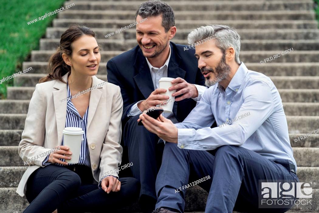 Stock Photo: Businesspeople relaxing in public park.