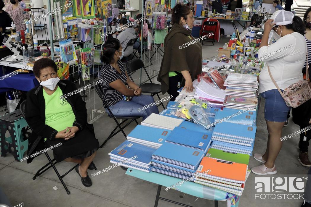Stock Photo: August 20, 2022, Mexico City, Mexico: Parents attend at the school supplies fair  at the Utopia Tezontli, to looked for school supplies for their children for.