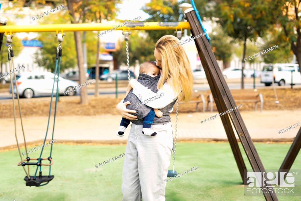 Stock Photo: Happy mother with baby boy on a playground.