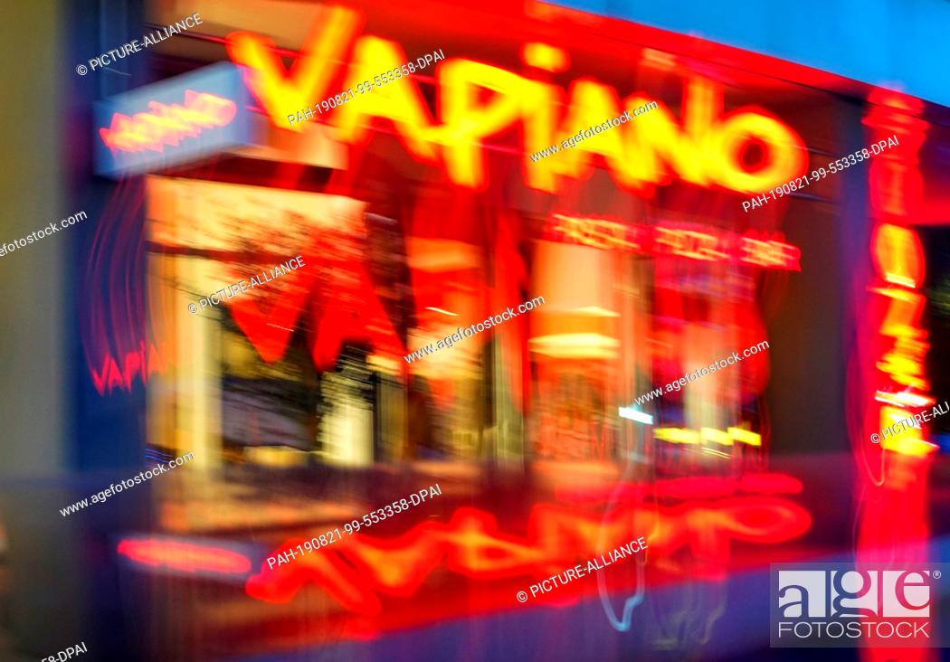 Stock Photo: 19 August 2019, Berlin: The entrance to a restaurant in the Vapiano chain (blurred by long exposure). The Cologne-based company intends to continue its.