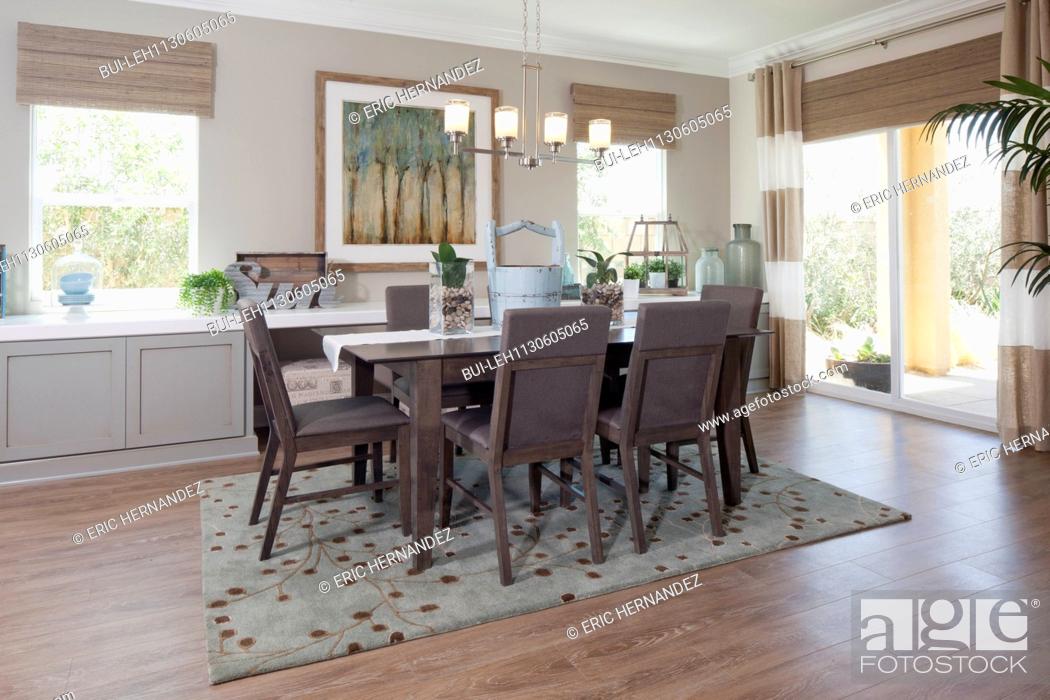 Dining Room And Area Rug In Middle Class House Stock Photo