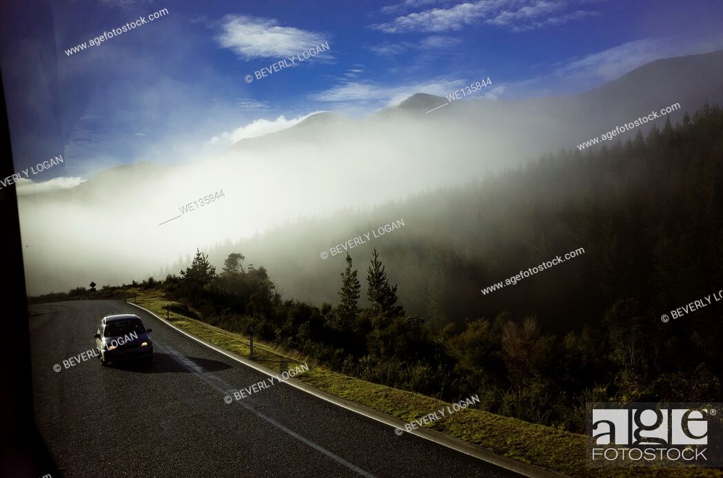 Stock Photo: Car driving on a foggy day in New Zealand.