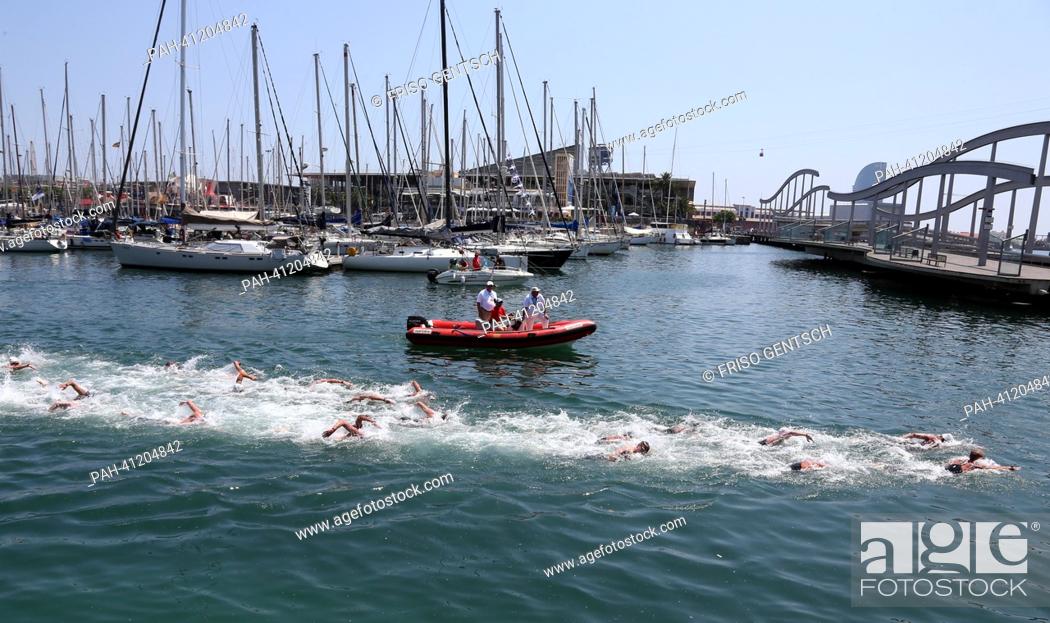 Stock Photo: Competitors swims along boats during the men's 10 km Marathon Open Water event of the 15th FINA Swimming World Championships at Moll de la Fusta on the coast of.