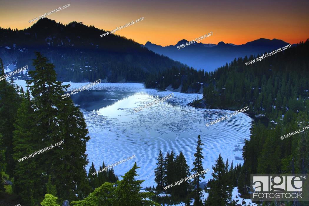 Stock Photo: Sunset Over a Partailly Frozen Snow Lake in the Alpine Lakes Wilderness of Washington.