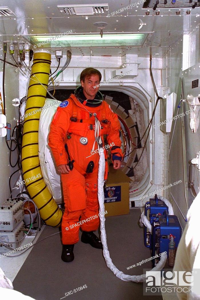 Stock Photo: 07/23/1997 --- STS-85 Payload Specialist Bjarni V. Tryggvason poses in the white room at Launch Pad 39A with his ascent/reentry flight suit as he prepares to.