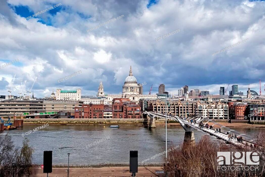 Stock Photo: LONDON - March 23: urban landscape with St. Paul's Cathedral and Millennium Bridge, officially known as the London Millennium Footbridge, on March 23.