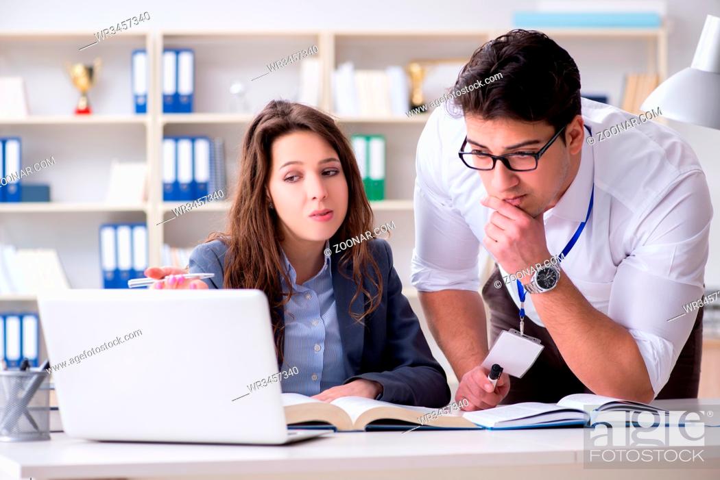 Stock Photo: Teacher explaining to student at lecture.