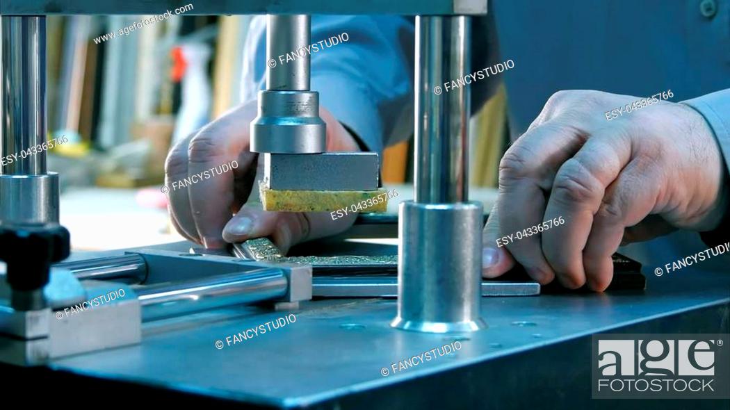 Stock Photo: Professional framer hand holding frame angle, working on machine. Close up. Professional shot in 4K resolution. 083. You can use it e.g.