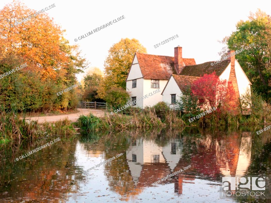 Stock Photo: willy lotts cottage at flatford mill in suffolk in autumn reflections in lake; suffolk; england; uk.