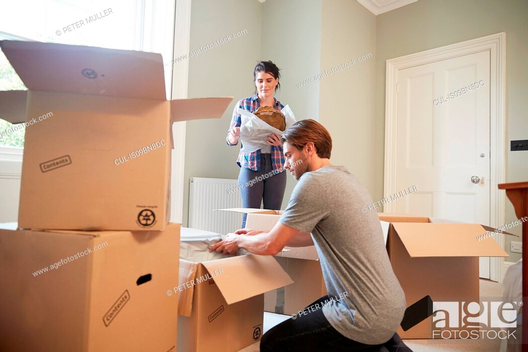 Stock Photo: Couple packing belongings in cardboard boxes.