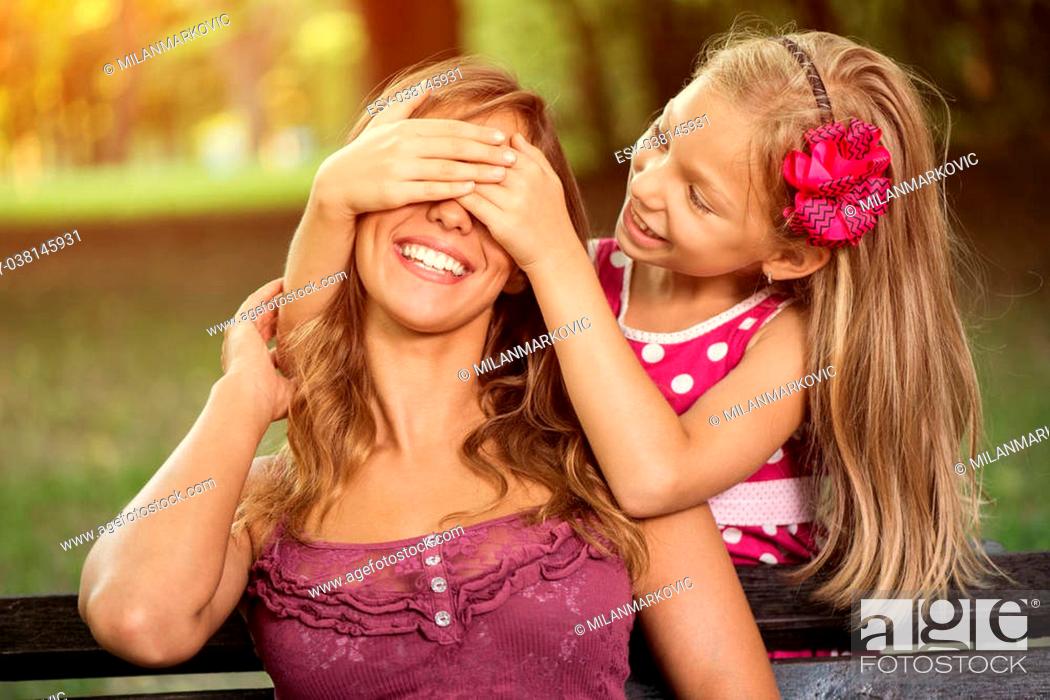 Happy Cute Little Girl And Her Mother Playing In The Park Stock