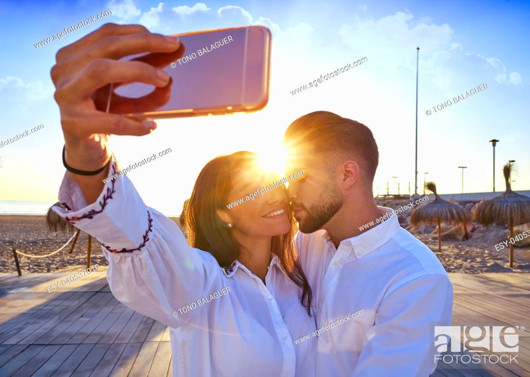 Stock Photo: Couple young selfie photo in beach together vacation sunrise at Spain.