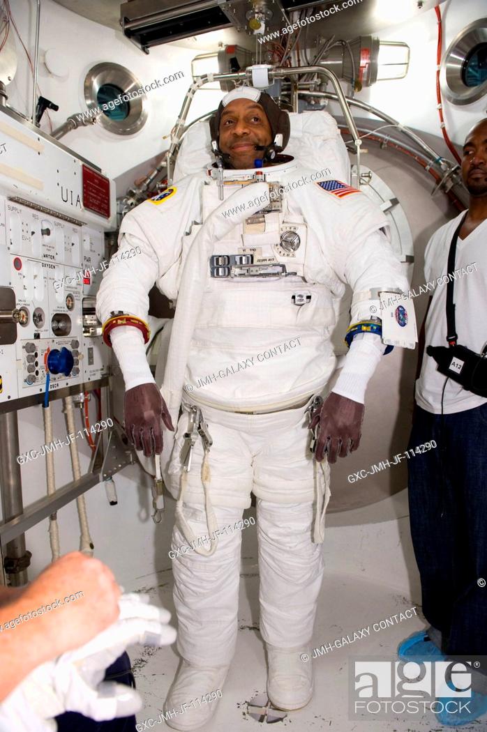 Stock Photo: Astronaut Robert Satcher, STS-129 mission specialist, participates in an Extravehicular Mobility Unit (EMU) spacesuit fit check in the Space Station Airlock.