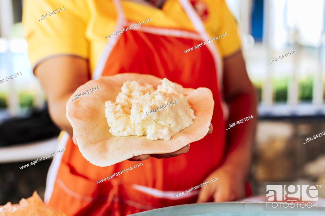 Stock Photo: Preparation of the dough for traditional Nicaraguan pupusas, Elaboration of traditional pupusas, Hands of a vendor showing traditional raw pupusa.