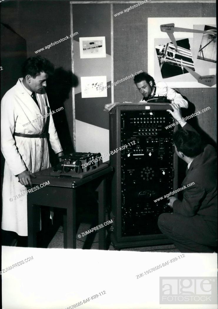 Stock Photo: May 05, 1957 - Exhibition Of Modern Physics Opens Et Grand Palais. Photo Shows: Engineers of an electronic Firi installing an electronic machine to be seen at.