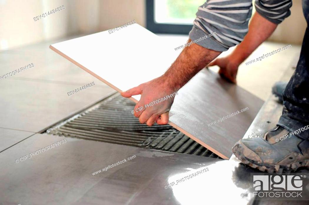 Man Laying Floor Tiles Stock Photo, How To Lay Hall Tiles