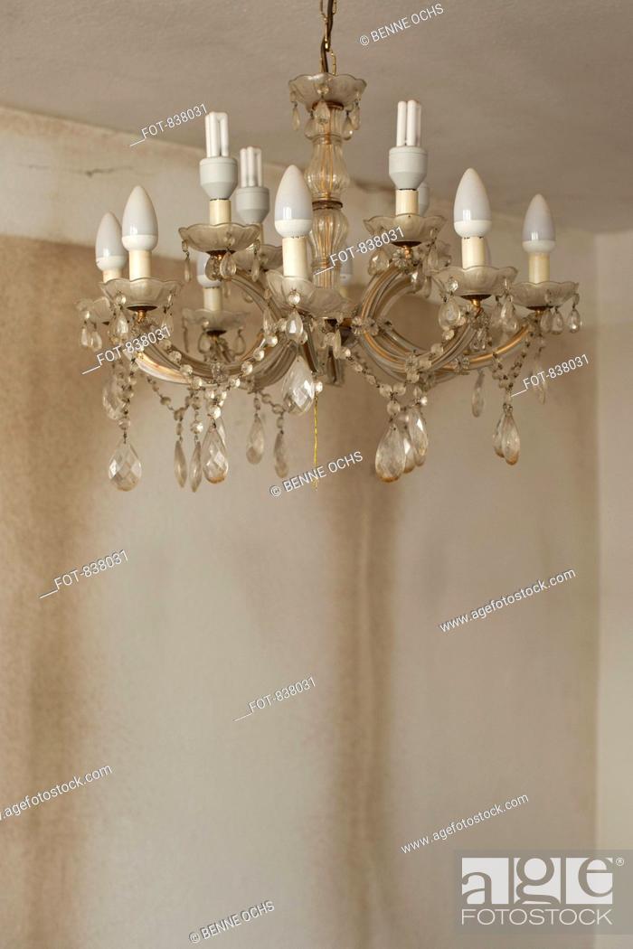 Stock Photo: Old and dirty chandelier hanging in bare room.