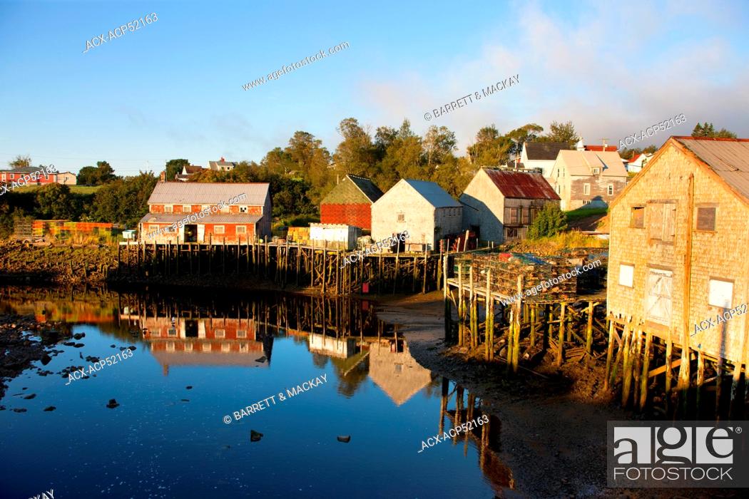 Stock Photo: Fishing shed reflected in harbour at low tide, Seal Cove, Grand Manan Island, Bay of Fundy, New Brunswick, Canada.