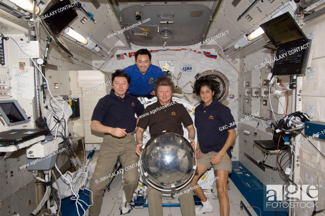 Stock Photo: Four of the six Expedition 32 crew members pose for a photo with a small ball-shaped science satellite in the Kibo laboratory of the International Space Station.