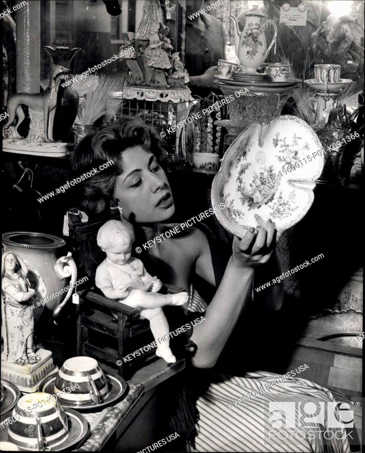Stock Photo: 1964 - Carole Searches for 'Props' in 'The delightful Muddle' Who could pass a shop with a name like 'The Delightful Muddle'? Beautiful actress Carole Newton.