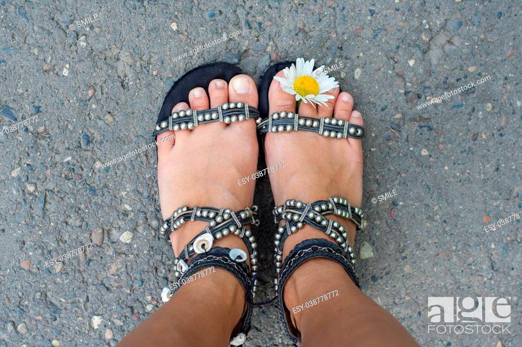 Stock Photo: Woman's feet with camomile flower between toes.