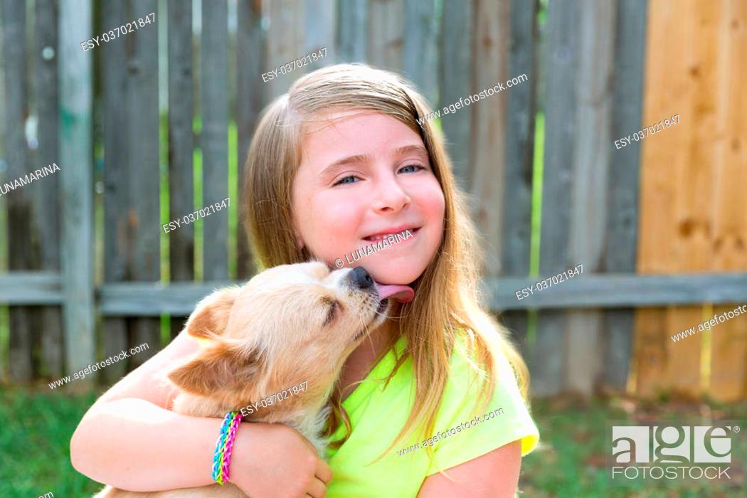 Stock Photo: Blond kid girl with chihuahua pet dog kiss playing happy outdoor.