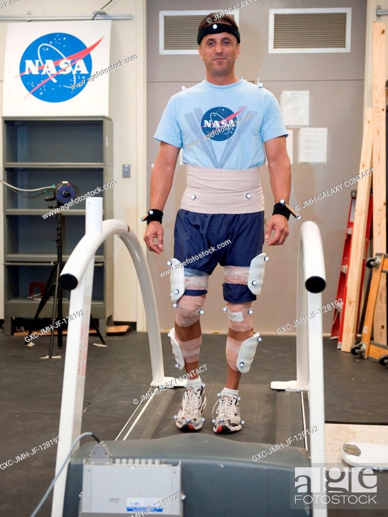 Stock Photo: NASA astronaut Joe Acaba, Expedition 3132 flight engineer, participates in a treadmill kinematics baseline data collection session in the Planetary and Earth.