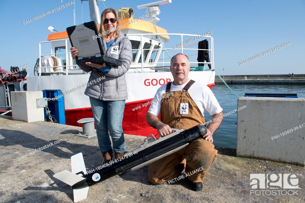 Stock Photo: 08 April 2018, Germany, Sassnitz: Carayton Fenn (l) and Terri Fenn, sonar experts from the US, help test a Marine Sonic Sonar in the Baltic Sea which is.