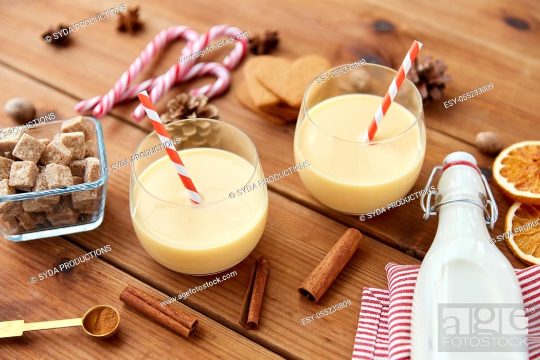 Stock Photo: glasses of eggnog, ingredients and spices on wood.
