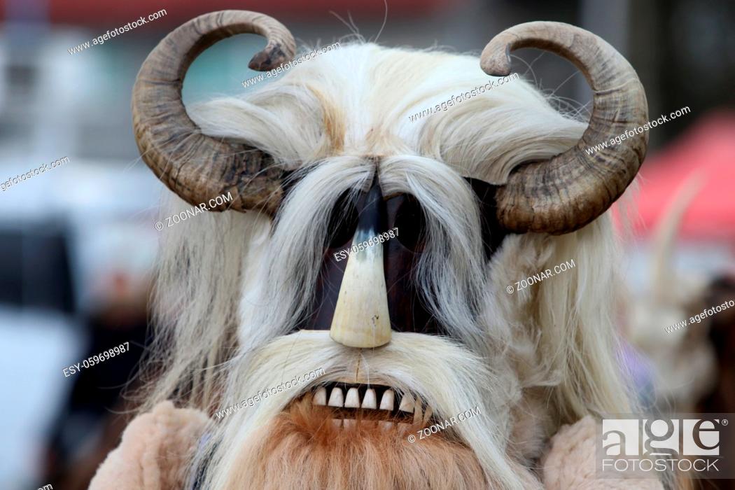 Stock Photo: Elin Pelin, Bulgaria - February 15, 2020: Masquerade festival in Elin Pelin, Bulgaria. People with mask called Kukeri dance and perform to scare the evil.