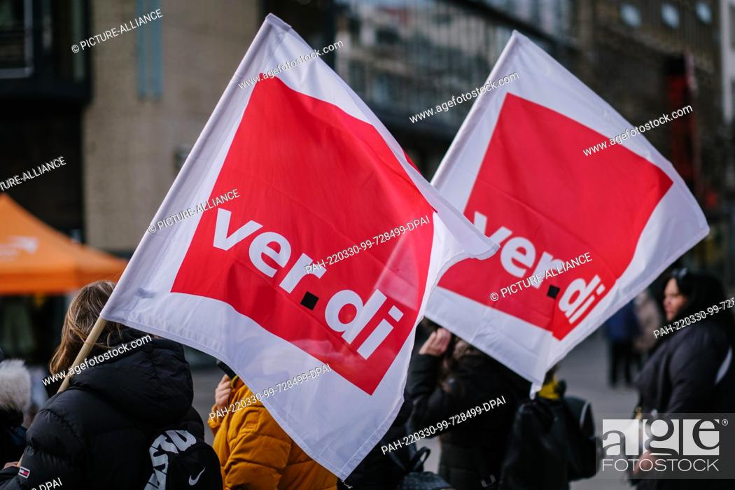 Stock Photo: 30 March 2022, Lower Saxony, Hanover: Employees of the social and educational professions demonstrate with Verdi flags in the city center.