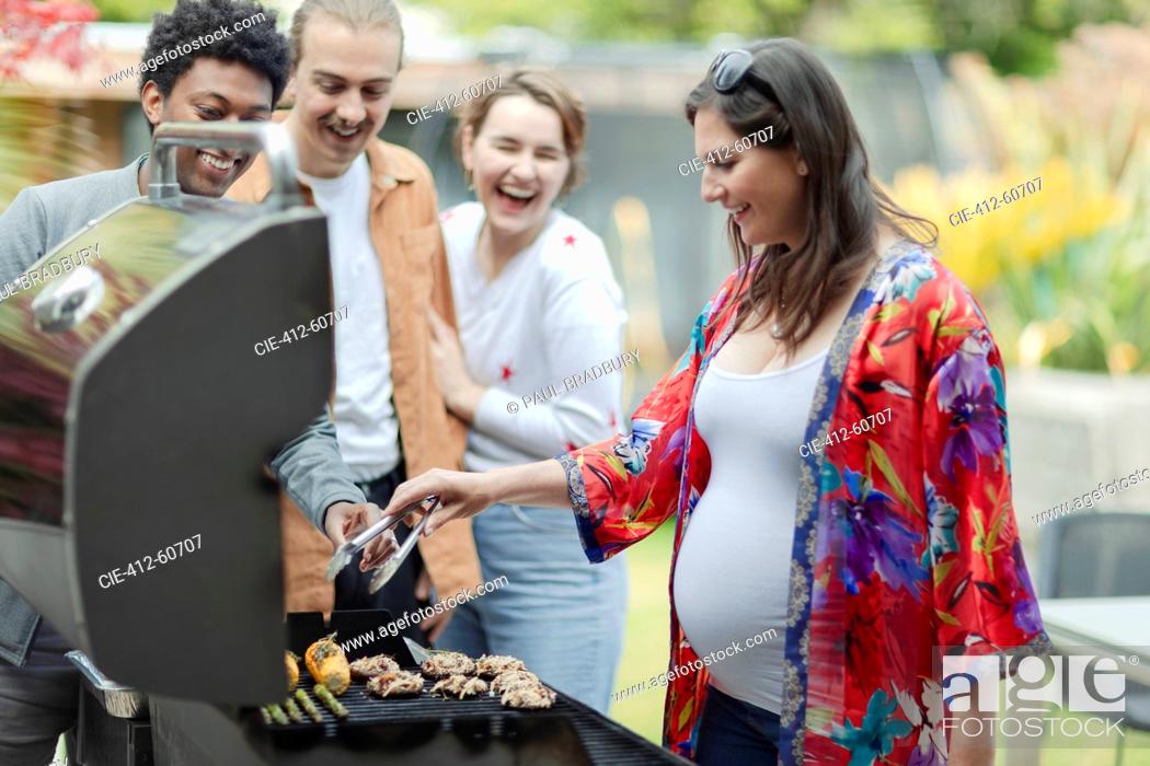 Stock Photo: Friends barbecuing vegetables on patio.