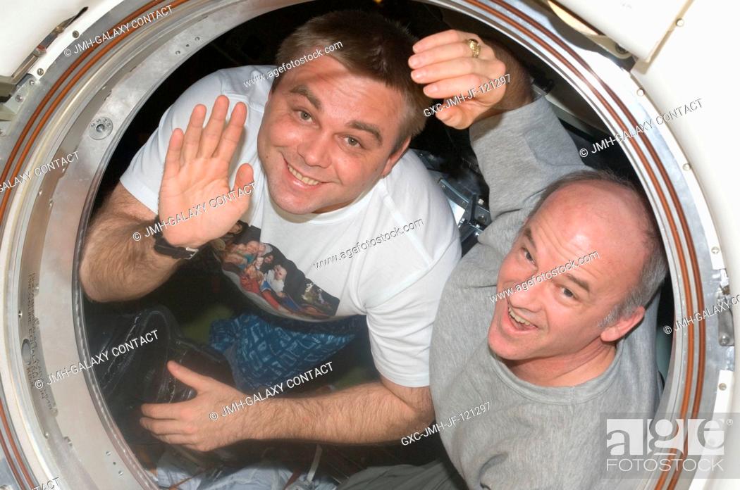 Stock Photo: NASA astronaut Jeffrey Williams (right), Expedition 22 commander; and Russian cosmonaut Maxim Suraev, flight engineer, wave good-bye to their crewmates on the.