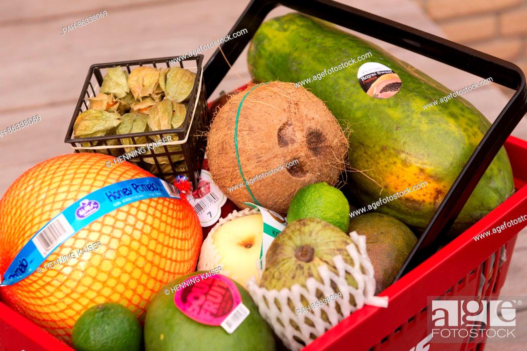 Stock Photo: A mango, nashi pear, physalis, pomelo, cherimoya, coconut and other varieties of exotic fruit seen in a shopping basket in Cologne, Germany, 07 December 2016.