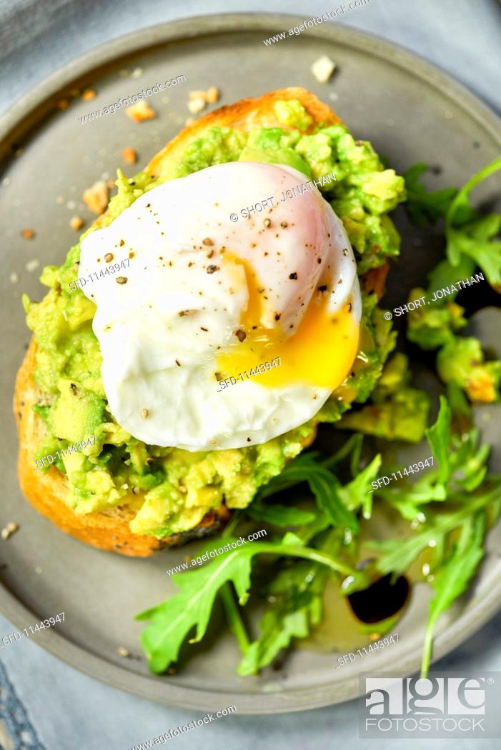 Stock Photo: Avocado and a poached egg on toast.