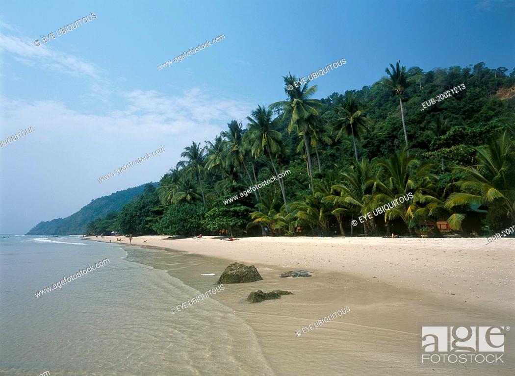 Stock Photo: White Sand Beach, Haad Sai Khao. View along sandy shore with lush green trees growing inland.