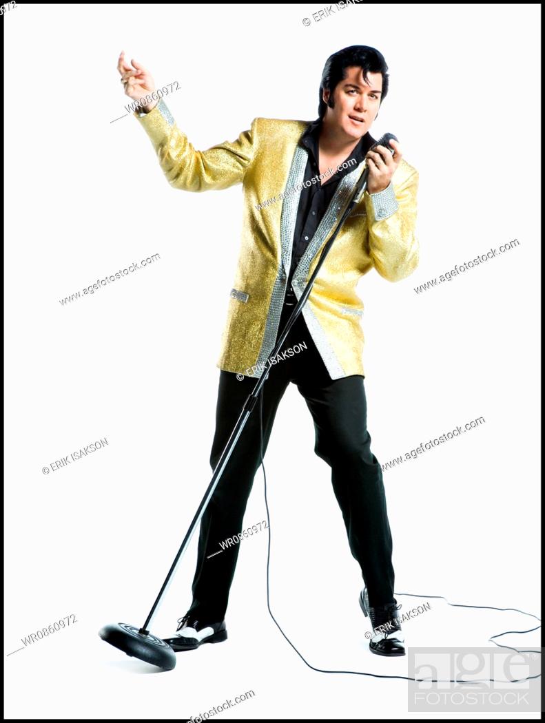 Stock Photo: An Elvis impersonator singing into a microphone.