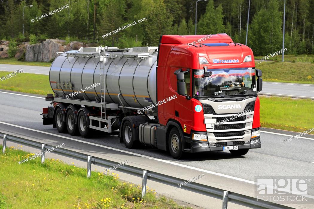 Stock Photo: Red Scania R450 semi tanker truck Tomega hauls load on motorway in South of Finland. Salo, Finland. May 28, 2021.