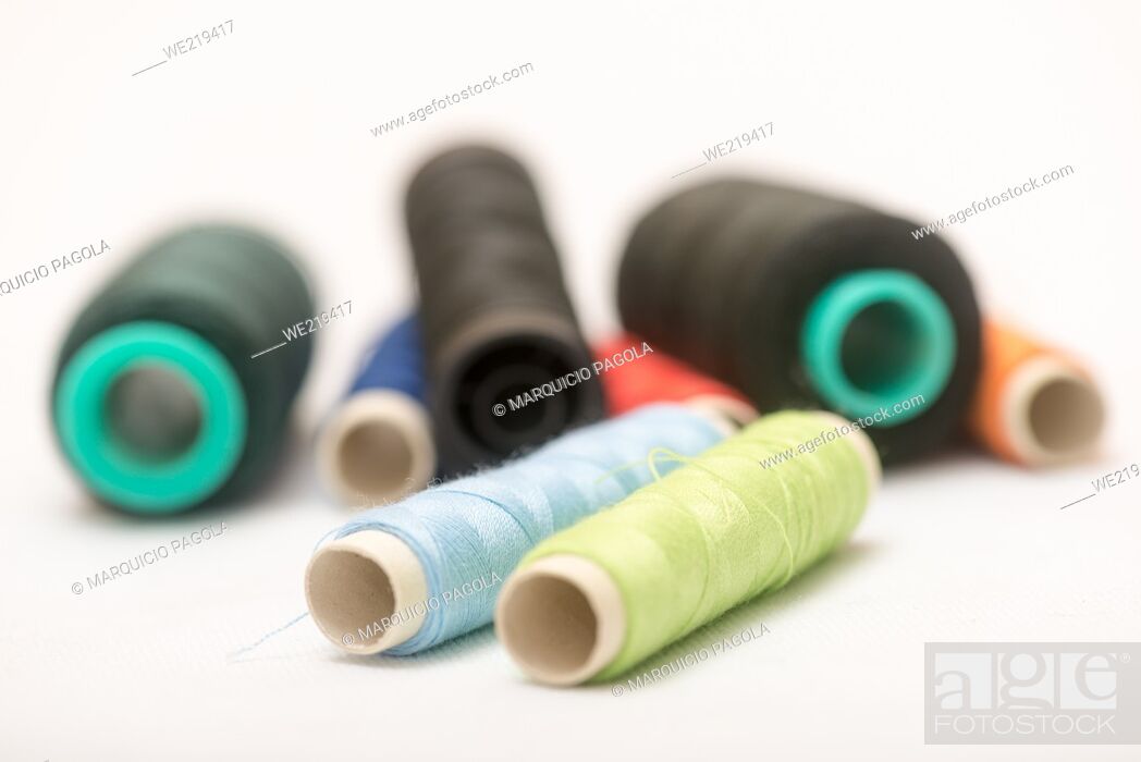 Photo de stock: set of colorful spools of thread on a white background.