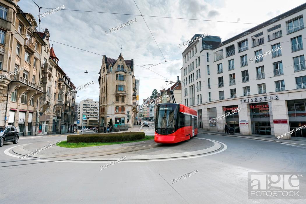 Stock Photo: St. Gallen, SG / Switzerland - April 8, 2019: the historic Appenzeller train rounds the Spisertor in downtown St. Gallen on ist way out of the city.
