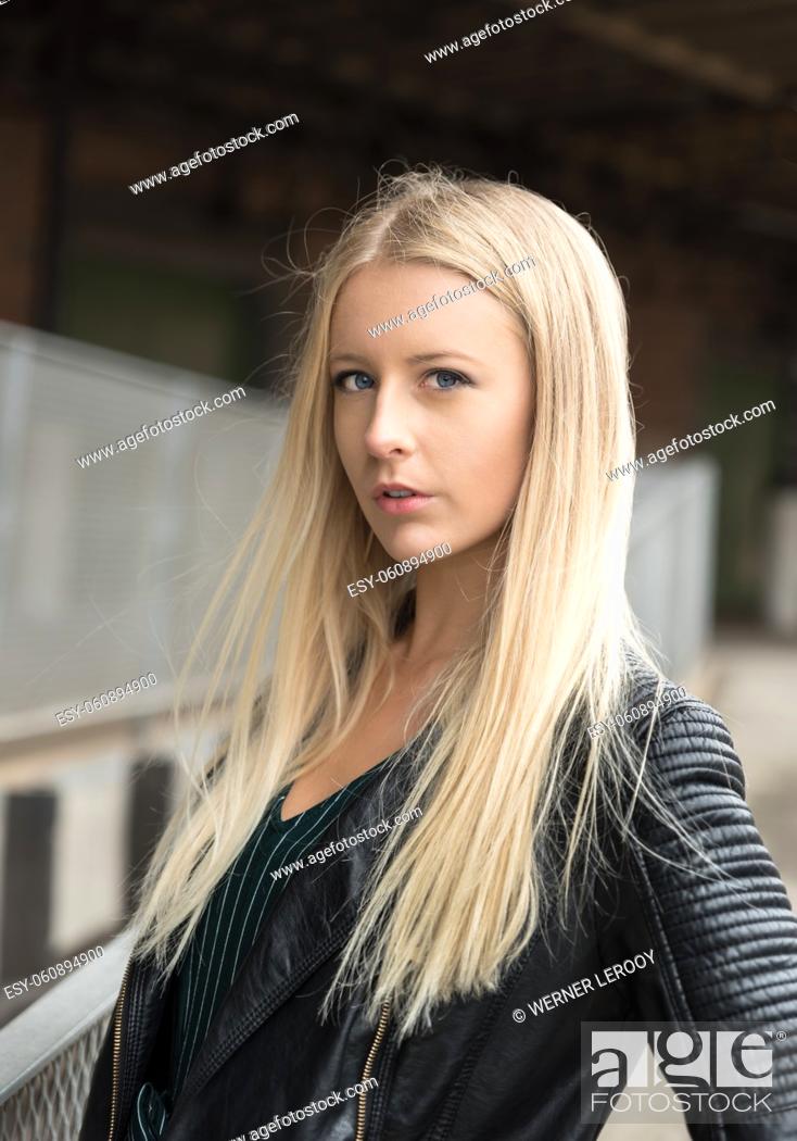 Stock Photo: Molenbeek, Brussels - Belgium - 11 30 2017: Pretty blonde teenage girl posing at the site of Thurn and Taxis.