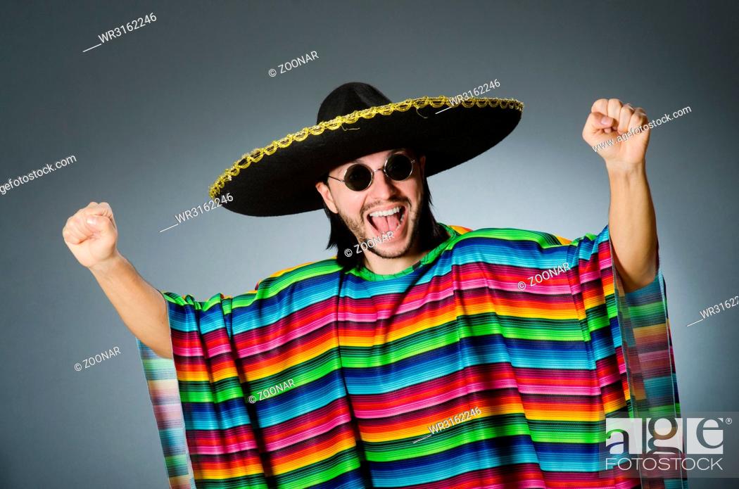Stock Photo: Man in a vivid mexican poncho gray background isolated.