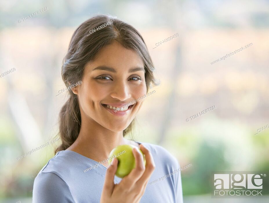 Stock Photo: Close up portrait smiling woman eating green apple.
