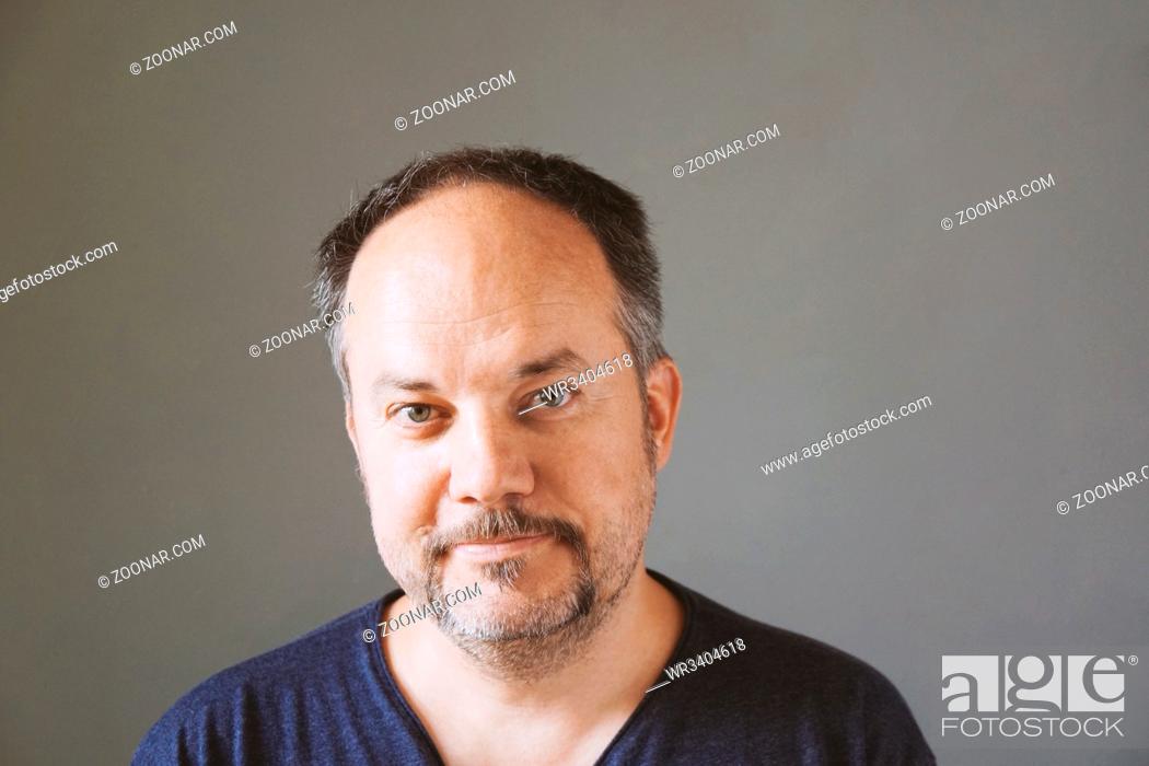 Stock Photo: smiling middle aged forty-something man with horseshoe mustache, real people.