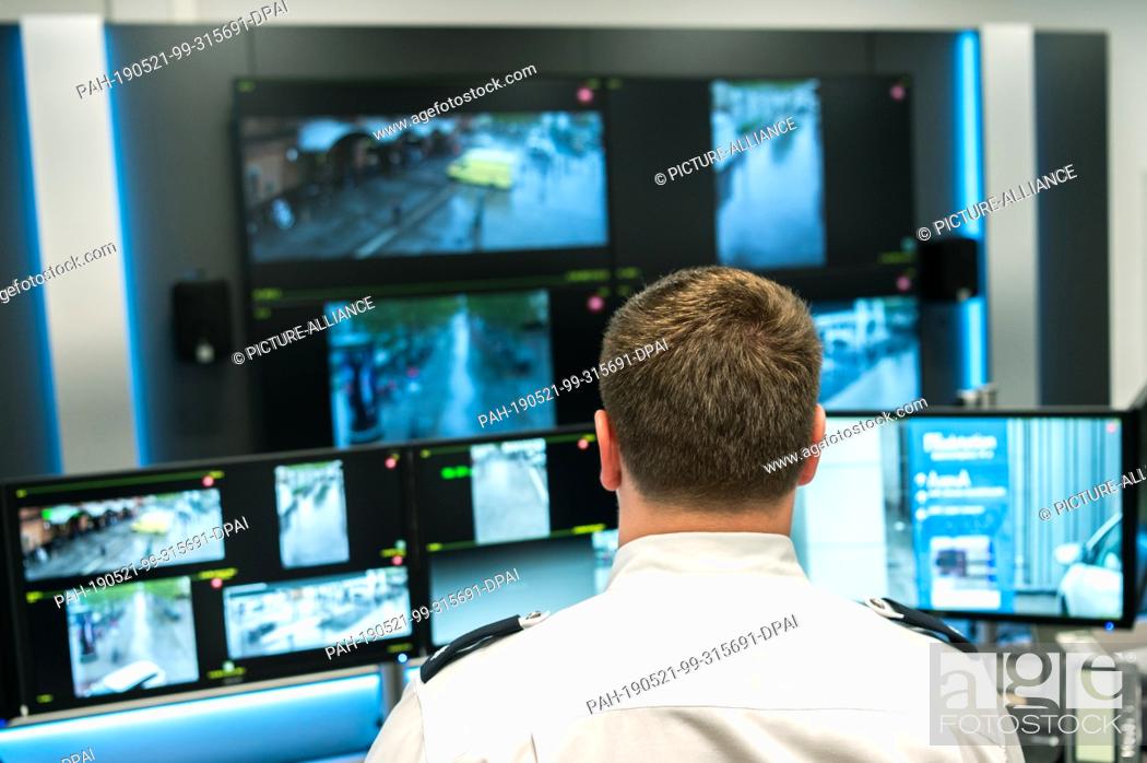 Stock Photo: 21 May 2019, Bremen: Police Commissioner Marco Walker stands in front of a table in a room of the Bremen Police Headquarters and looks at monitors on which the.