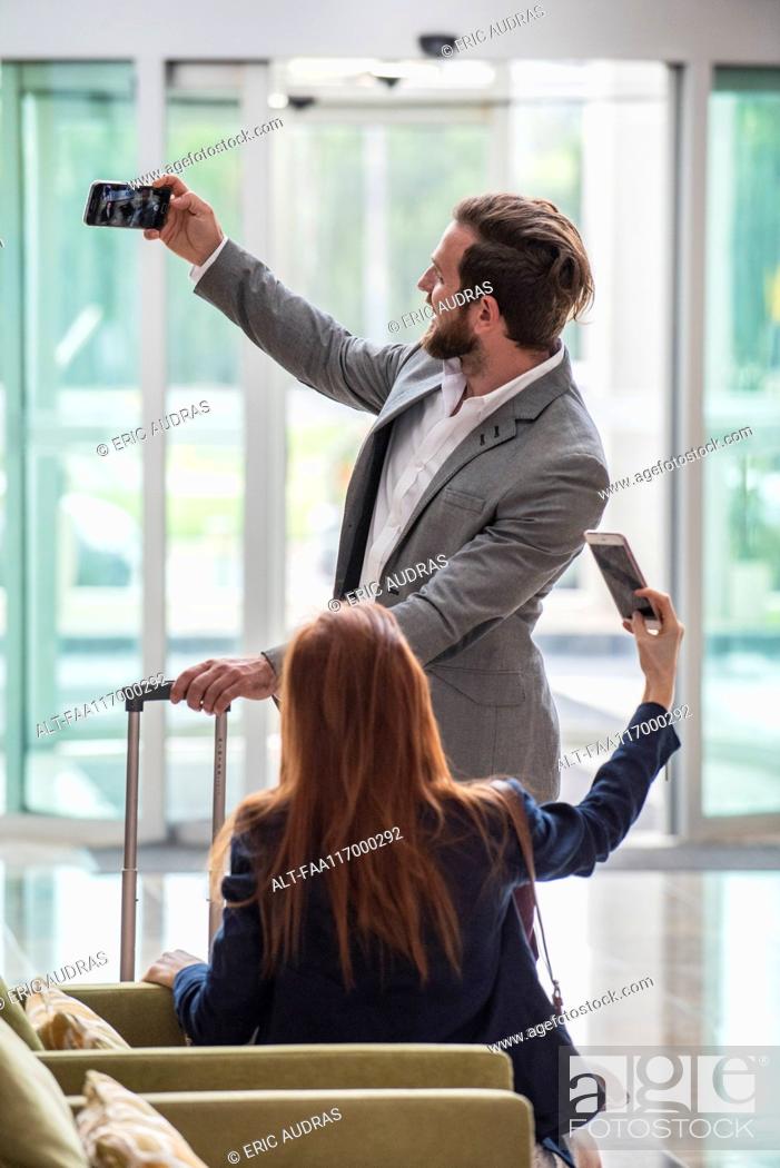 Stock Photo: Business people taking selfie with smart phone.