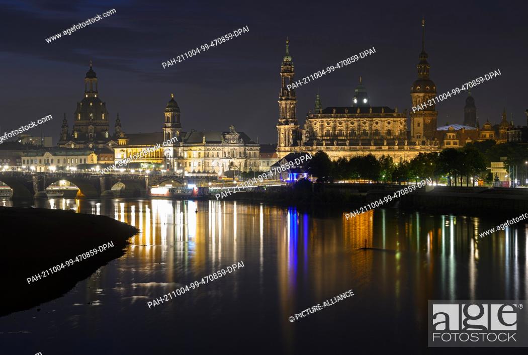 Stock Photo: 04 October 2021, Saxony, Dresden: Panoramic view in the morning onto the historical old town scenery at the river Elbe with the Frauenkirche (l-r).
