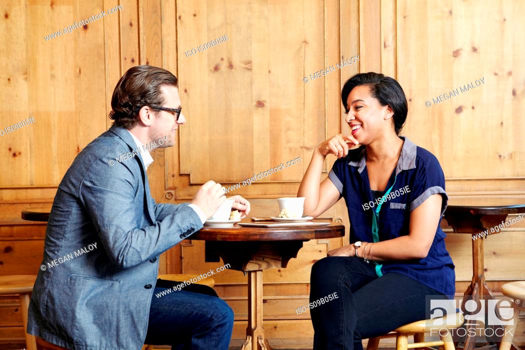 Stock Photo: Man and woman sitting in cafe drinking coffee.