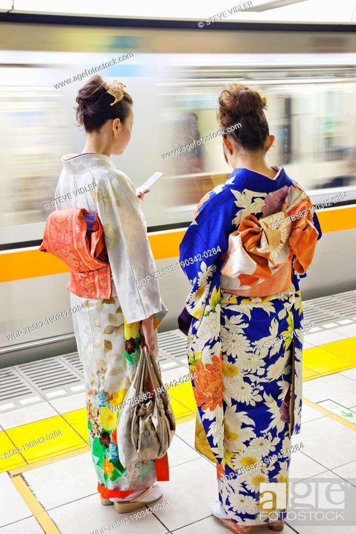 Stock Photo: Japan, Tokyo, Girls in Kimono on Subway Platform.