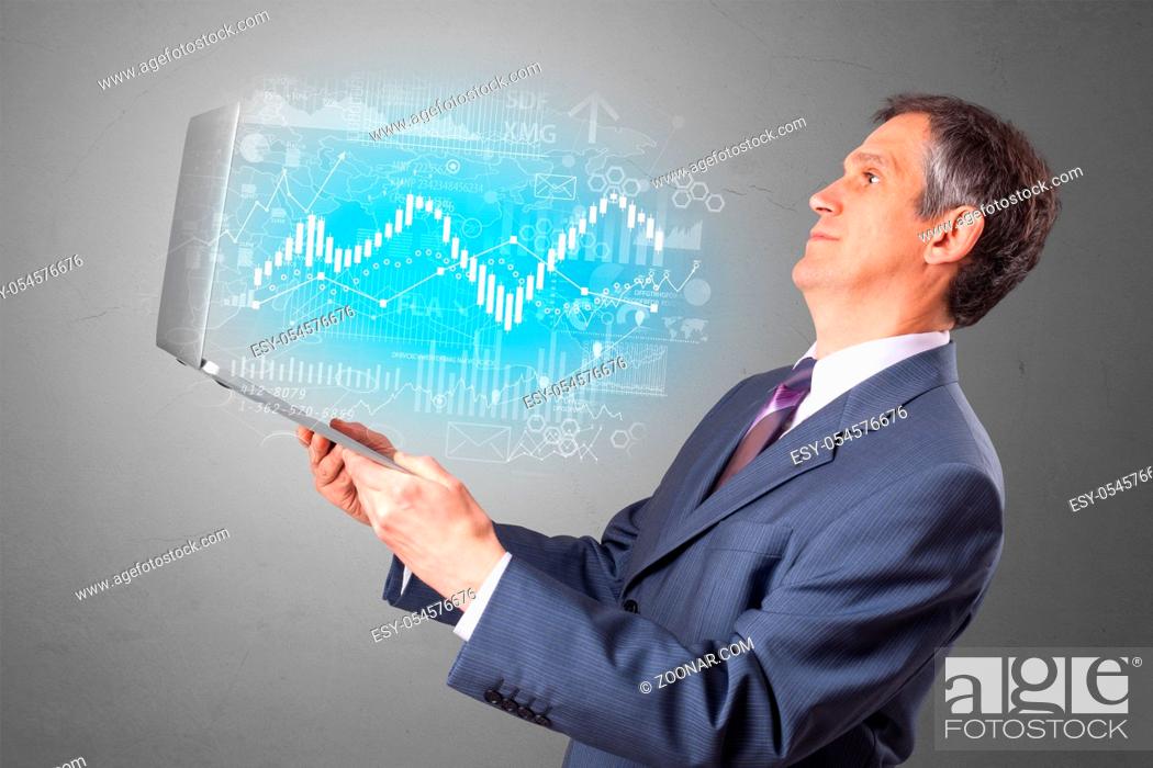 Stock Photo: Man holding laptop projecting financial information, diagrams and charts.